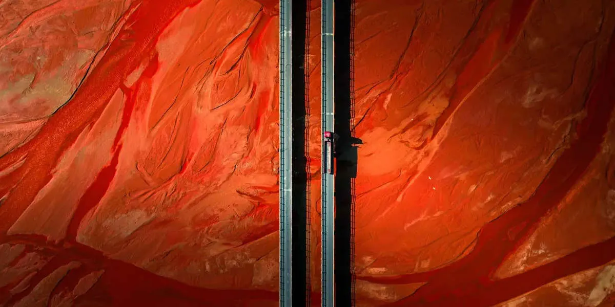 home hero image of bridge through a desert taken with a drone