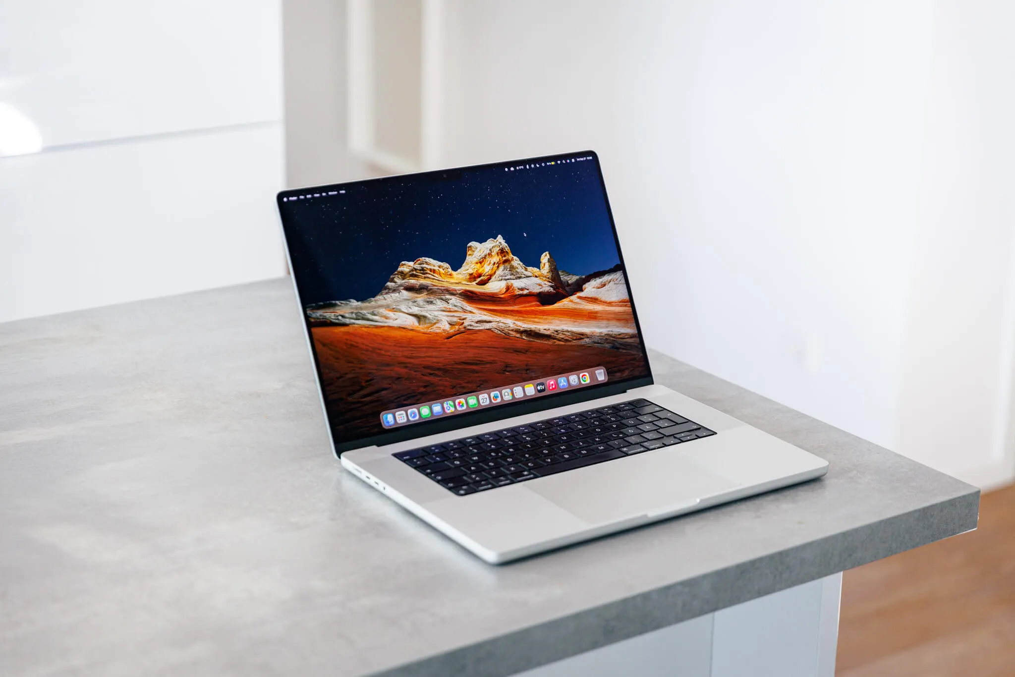 A MacBook Pro on a concrete desk
